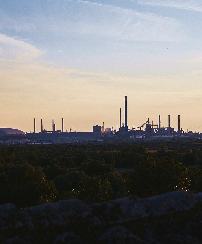 Taranto's steelworks at dusk seen from the countryside